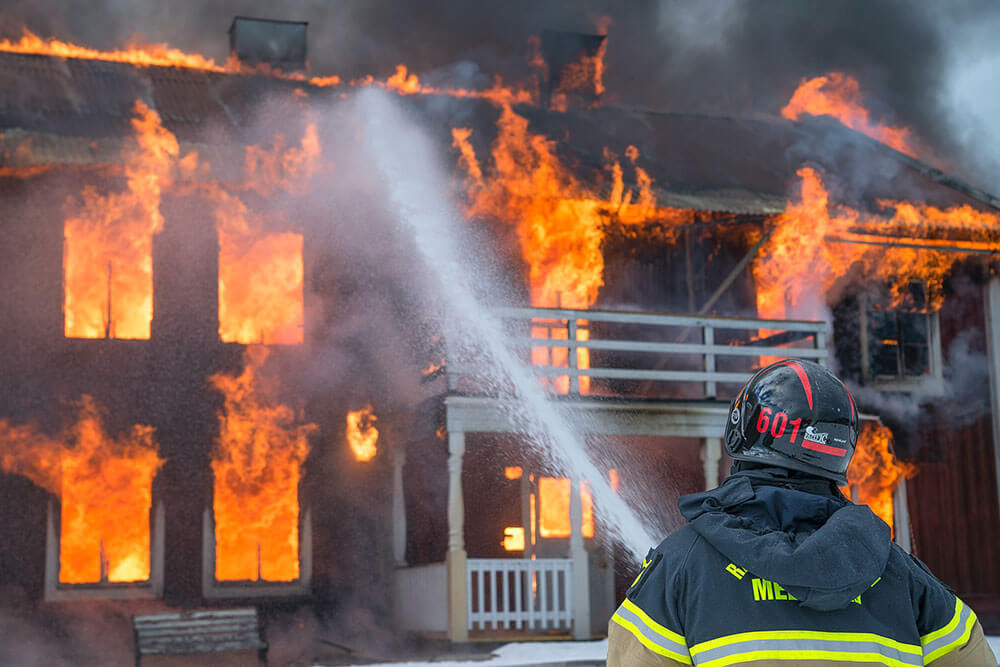 Firefighter putting out a house fire